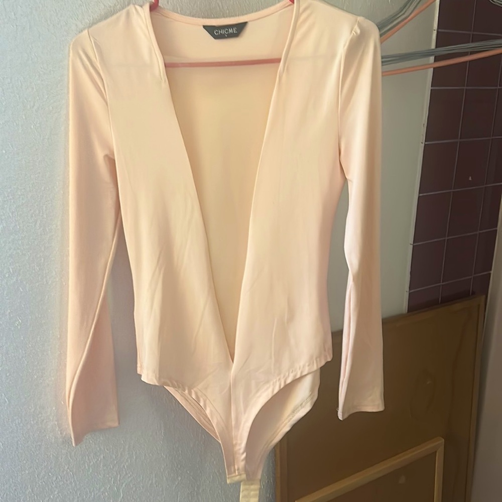 Bodysuit, silk with sheer see thru v in front. Very sexy and classy.